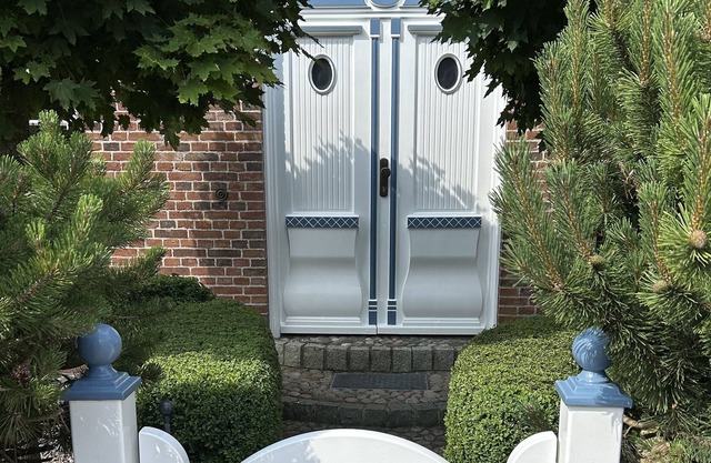 Une maison mitoyenne au toit de chaume avec un espace de stationnement pouvant accueillir jusqu'à 2 voitures.