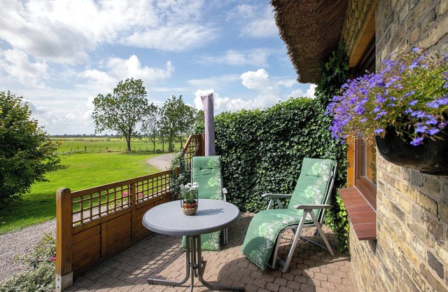 Appartement 'Ferienwohnung Am Eiderdeich' avec terrasse privée, jardin partagé et Wi-Fi