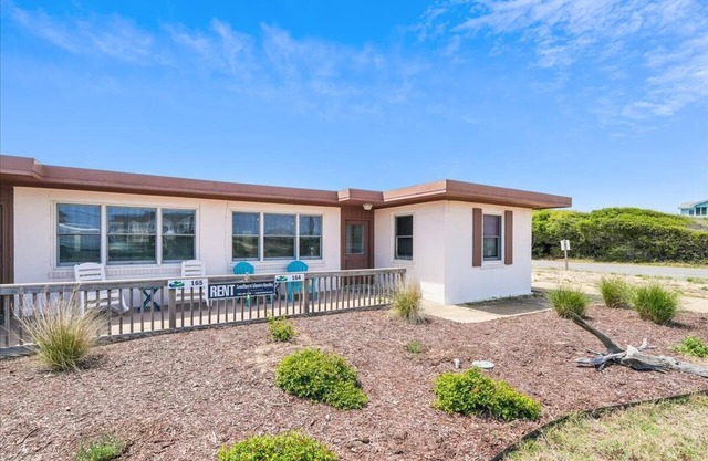 One of the original 'flat-tops' in Southern Shores, this bright duplex is just steps from the beach!