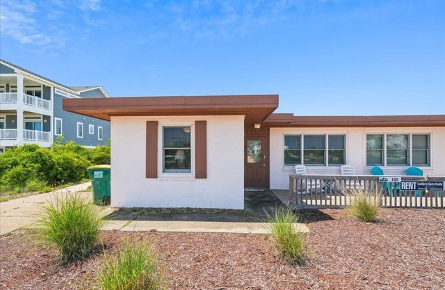 One of the original 'flat-tops' in Southern Shores - this airy duplex is steps from the beach!