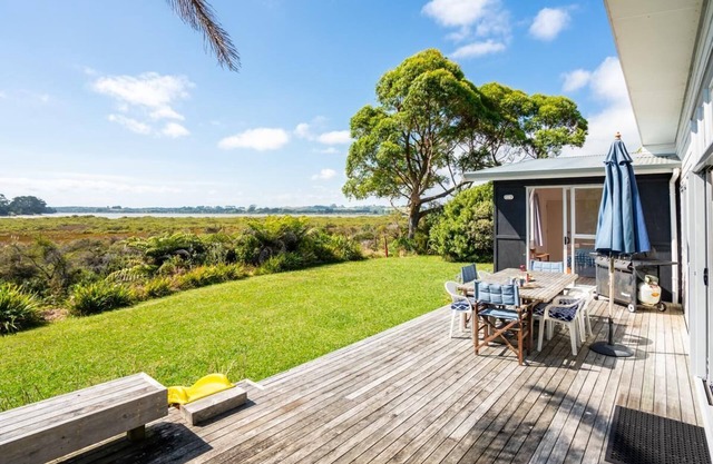 Wintle93 - STUNNING VIEWS await you from the living areas and sunny deck of this traditional kiwi bach which has been tastefully modernised and is within a few minutes walk to both surf beach and estuary beaches. Pet friendly and FREE wifi included!