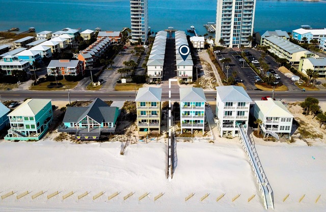 Beach-view cottage near beach with pool, wrap-around balcony, boat dock, W/D, AC