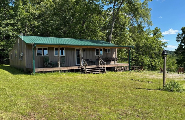 Serene 2-Bedroom Cabin Nestled in a Peaceful Wooded Setting with a Scenic Pond.