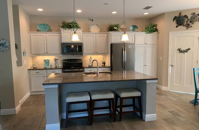 Beautiful spacious 3 bedroom/ 2 bath pool home with an outdoor kitchen
