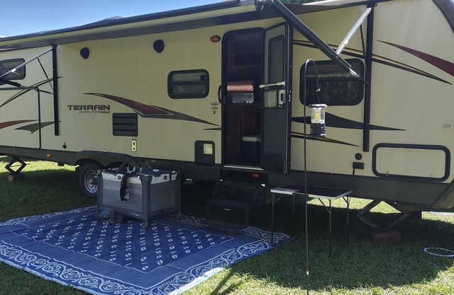 Beautiful travel trailer with private fenced in yard, deck, and fire pit.