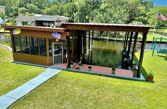 BEAUTIFUL WATERFRONT . GNAT SCREENED BOATHOUSE AND AJOINING COVERED BOAT SLIPS