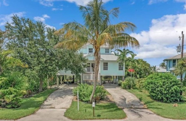 Beautiful waterfront Key West style home with a pool