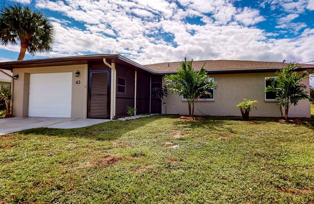 Blue sky retreat near the water with updated living quarters, beach gear, and AC