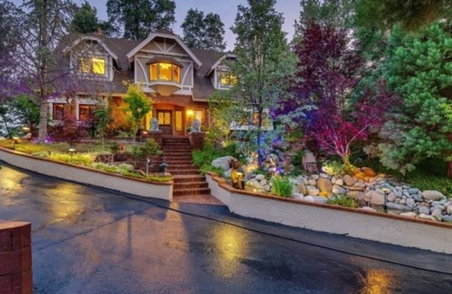 An estate w/ lake views, indoor hot tub, sauna, basketball court & movie theater