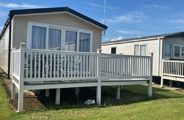 Caravan with large decking at Coopers Beach Holiday Park ref 49012SV