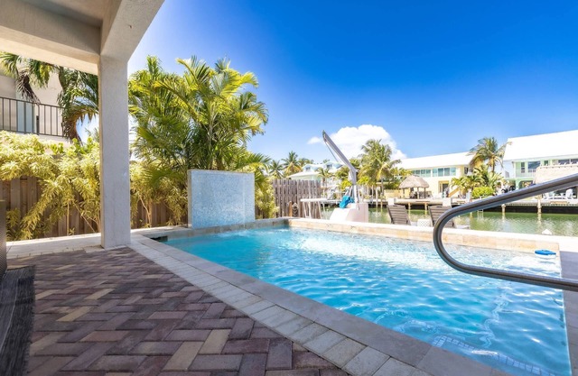 Casa Paraiso: Discover This Charming 2BR Canal Front Duplex in KCB with Private Pool & Dockage!