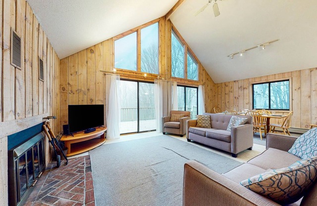 Charming home with fireplace, game room, full kitchen, gas grill, & balcony