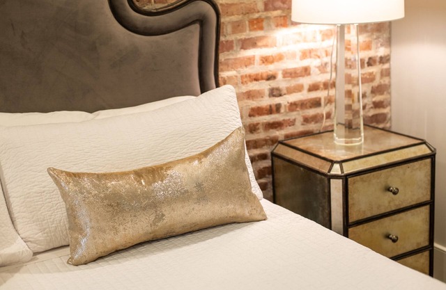 Chic and Sleek Elegance: Stylish Retreat with Exposed Brick in New Orleans' CBD
