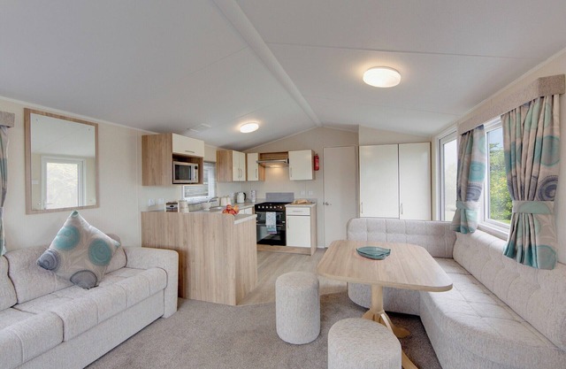 Contemporary caravan with one double with TV, and two twin.