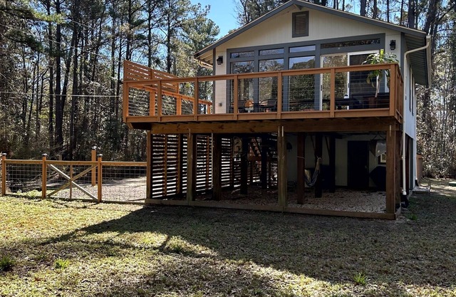 Cozy coastal oasis w/ wooded views and wrap around deck. Close to Dauphin Island