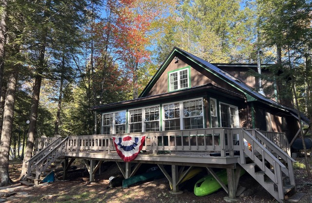 Cozy Sebec Lake front cabin with dock and fire pit