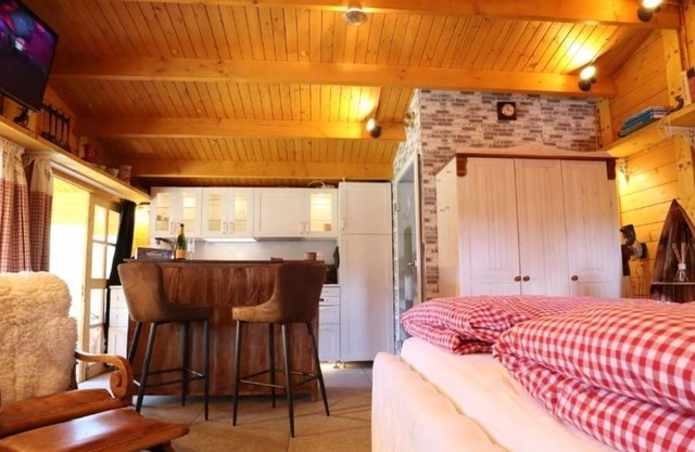 Cozy wooden cottage quietly situated behind the dike with terrace