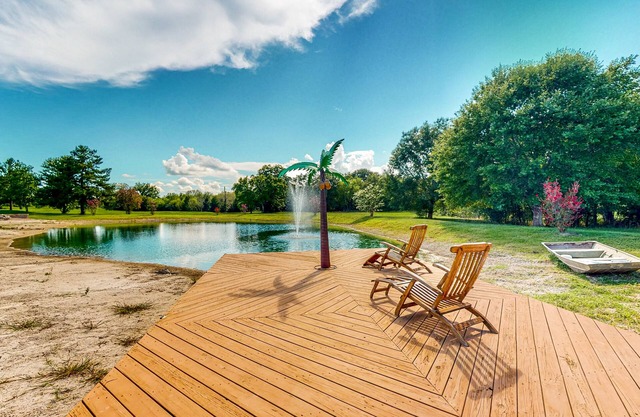 Custom home with guesthouse, pond, sunning deck, beach & tropical bar