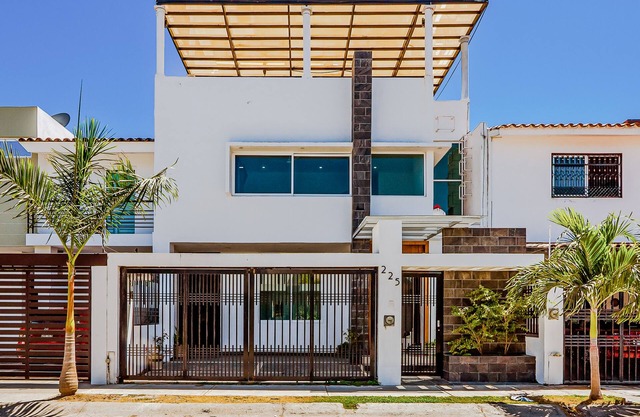 Dazzling estate with a pool, rooftop balcony, four-bedrooms, washer/dryer, & AC