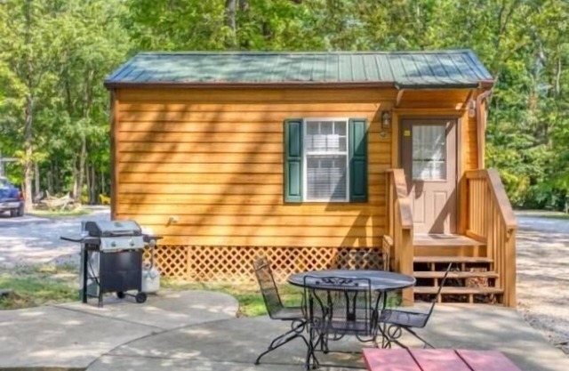 Deluxe Cabin (w/ Bathroom) - Deluxe Cabin (w/ Bathroom) Better than a motel! Enjoy camping in comfort! Kitchen with stove top and full size fridge with dishes pots included. Full bathroom with shower. Cable TV DVD player. Gas grill on your own concre