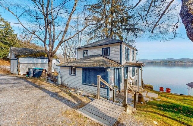 Dog-friendly cabin on the water with a sunroom, firepit, & full kitchen