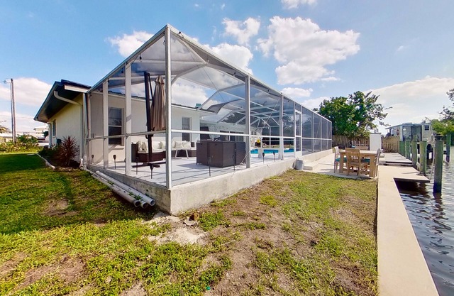 Dog-friendly home with private pool, dock, fireplace, patio, grill, & canal view