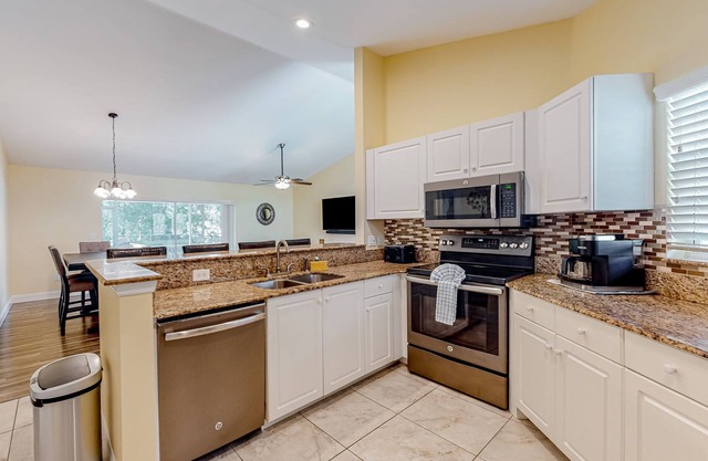 Dog-friendly home with fenced yard, screened lanai, hot tub, & ping pong