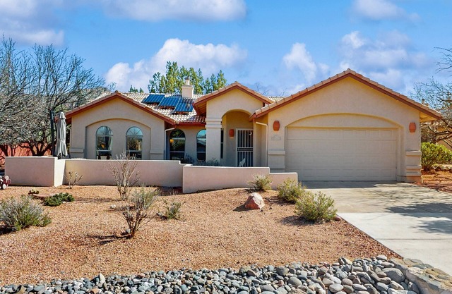 Dog-friendly home with garden patio, fireplace, & views of red rock cliffs