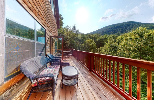 Dog-friendly mountain cabin with a furnished deck, game room & private hot tub