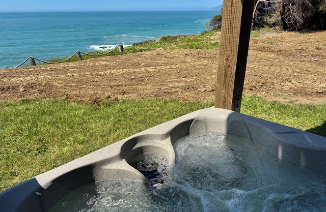 Dolphin by OceanviewHotTubs Tesla charging Oceanfront Shelter Cove