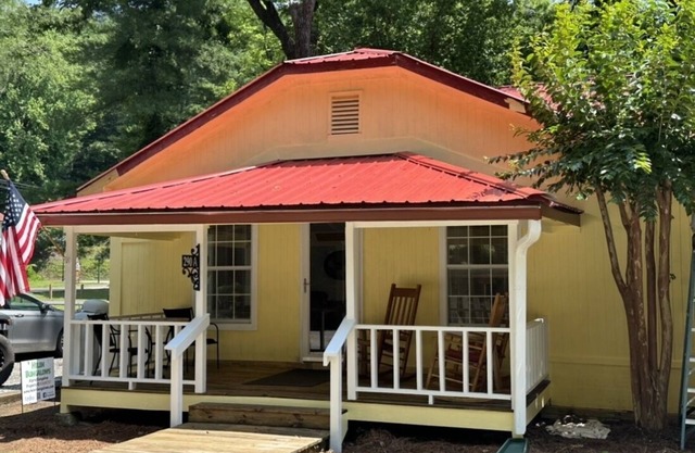 Downtown by Chattahoochee River, sit on front porch as horse and buggy stroll by