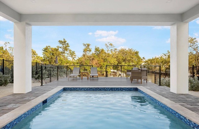 Edgewater Escape: Luxury Eco Canal-Front Home Near Beach with Pool & Dock
