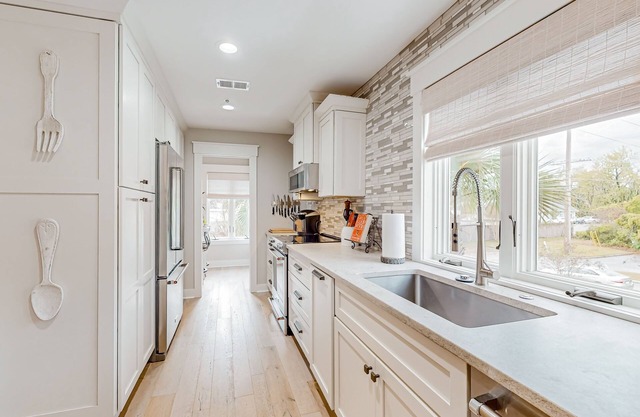 Elegant retreat near the sea with a covered balcony, chef's kitchen, W/D, & AC