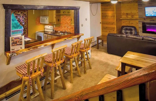 Enjoy a quiet stay on your own private deck by the lake in Room 21: Ponderosa-a Western Themed Chalet