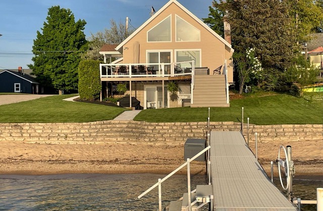 Enjoy Crystal Lake's pristine water and amazing sunsets from this lakefront home