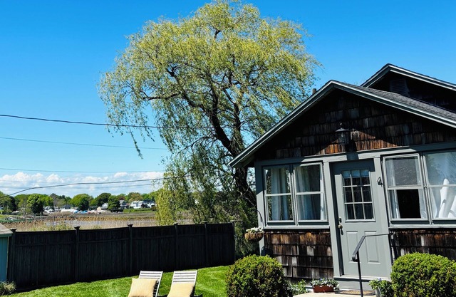 Chic waterside Bungalow is stylish and secluded with harbor and beach views.