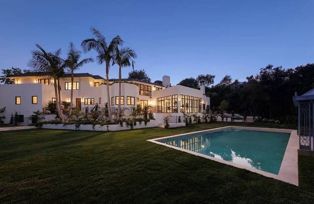 Experience luxury living in this private city-to-ocean view estate nestled in Mandeville Canyon