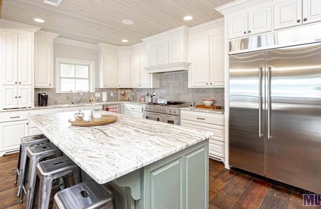Open and luxurious home on False River with pier and screened in porch!