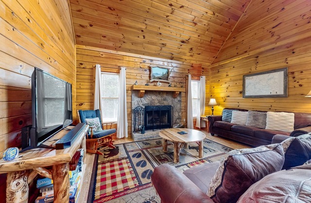 Forest-view cabin with pool, hot tub, fireplace, deck, & free attraction tickets
