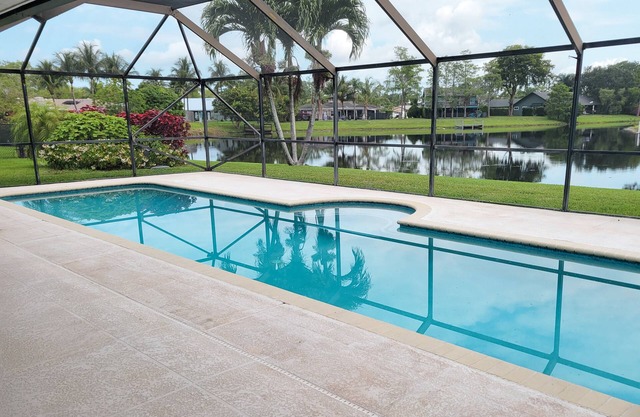 Golf cart distance to WEF! Charming 3 bedroom waterfront home with heated pool.
