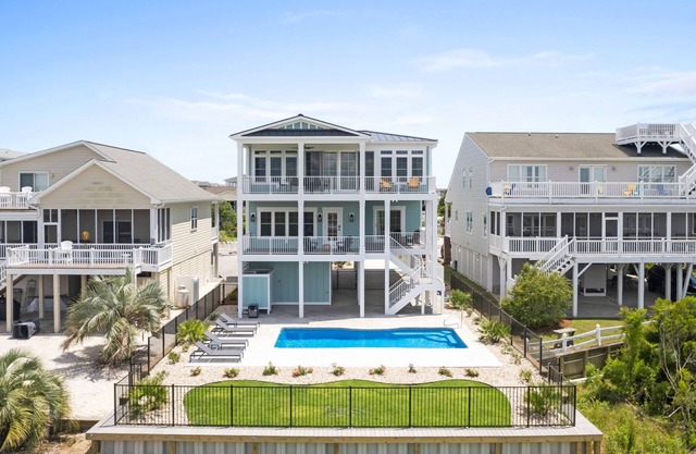 Here Comes the Sunset is a gorgeous home with incredible views of the Sunset Beach Intercoastal waterway and just a short walk to the beach!