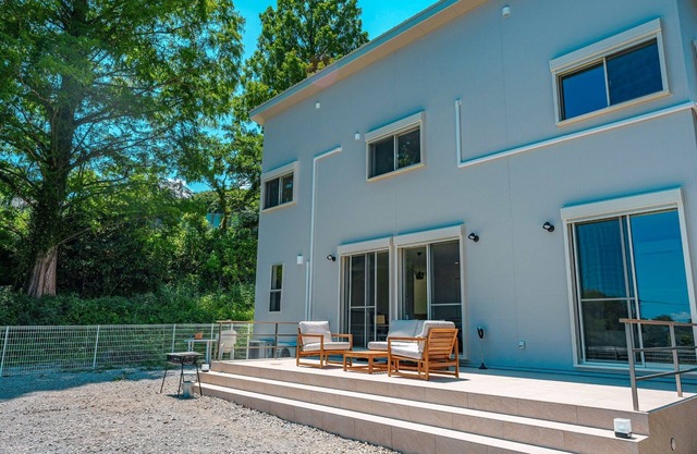 House surrounded by trees with a dog run / Kamogun Shizuoka