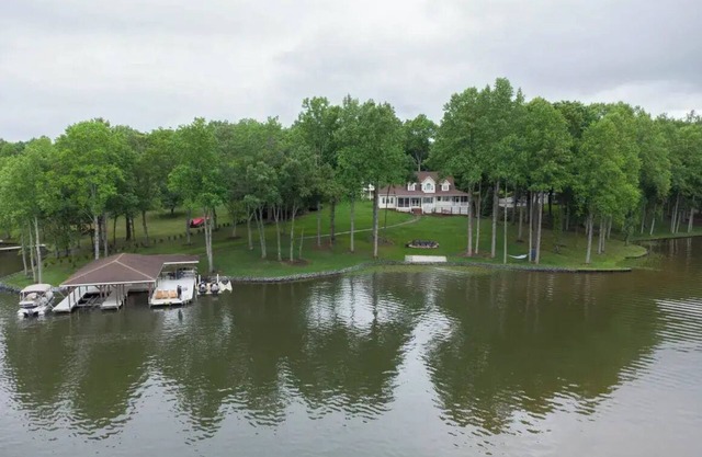 Lakefront home with private dock, kayaks, beach, badminton, firepit, & deck