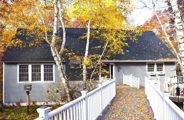 Charming Cottage + Modern Luxuries at this Wooded Lakeside Retreat