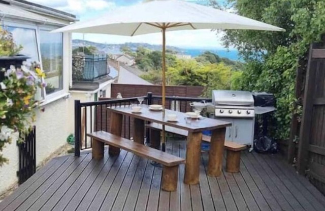 Large detached 3 bed bungalow. Great sea views. Hot tub with private gardens.