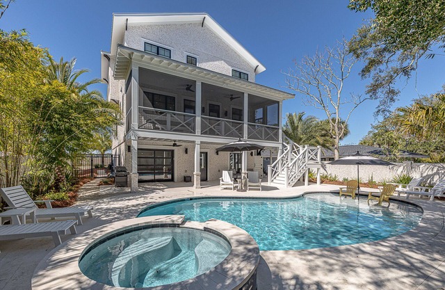 Large marsh front home with private pool and short walk to beach.