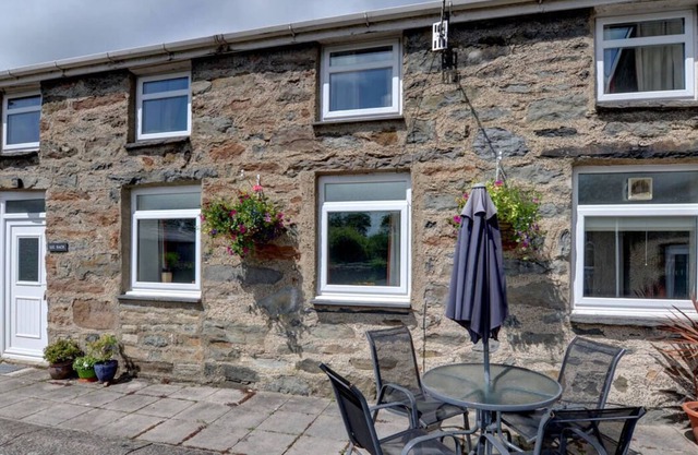 Près de Porthmadog, à côté de la ferme des propriétaires, se trouve Lle Bach, une maison avec son propre patio et