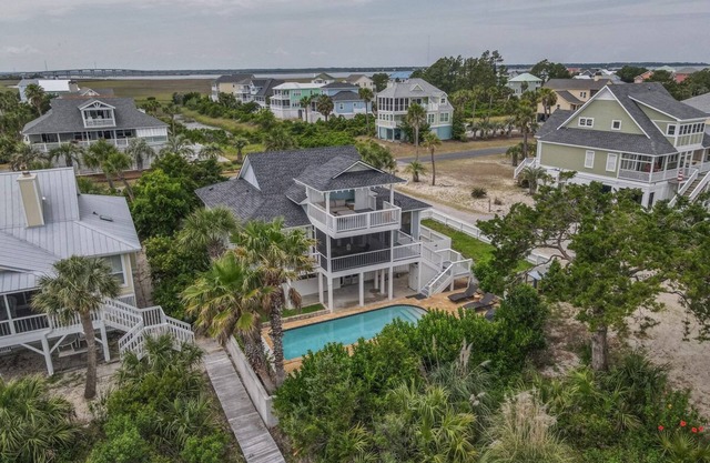 Lovely home with boardwalk beach access, water views, saltwater pool, and screened-in porch