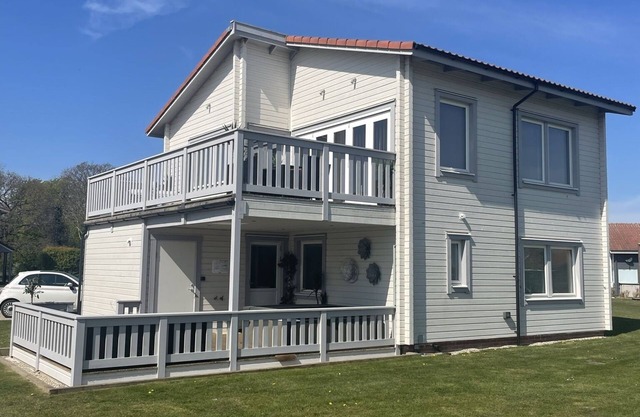 Luxury Scandinavian style lodge with own hot tub & sauna on golf resort.