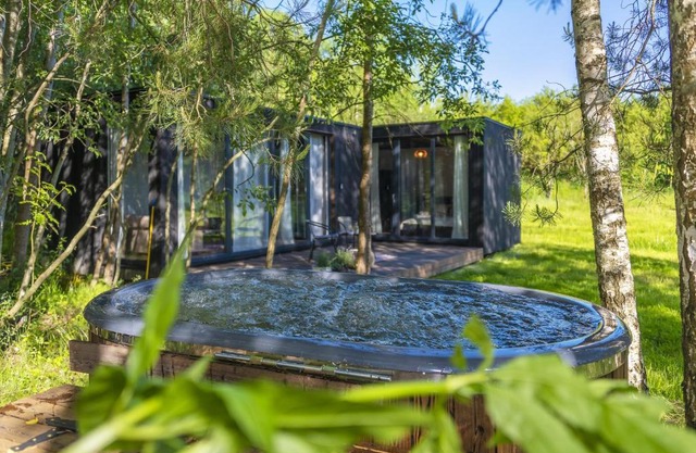 Modern and specious riverside cabin with hot tub